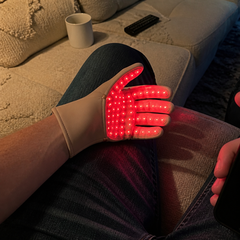 Velora Hand Glow LED glove worn at home during a session