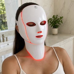 Woman testing the Velora LED face and neck mask