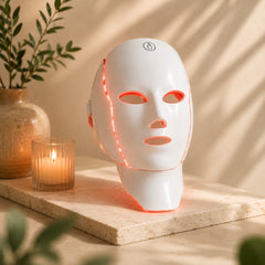 Velora LED face and neck mask standing alone — white two-piece device, red LEDs on