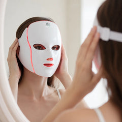 Woman putting on the Velora LED face mask